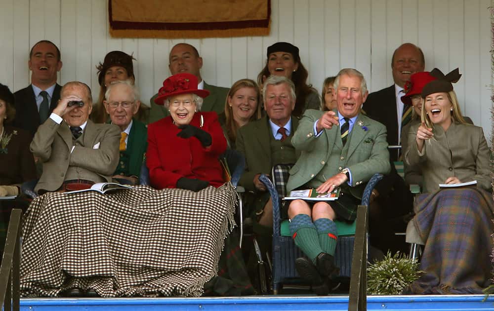 Britain's Queen Elizabeth, second left, laughs with The Duke of Edinburgh, left, Prince Charles, second right, and Autumn Phillips, during the Braemar Royal Highland gathering, near Britain's Queen Elizabeth II Balmoral estate, Aberdeenshire, Scotland.