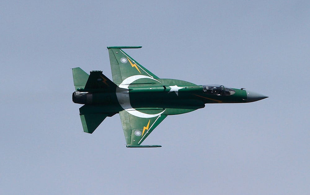 A Pakistani JF-17 fighter aircraft flies in a formation during a ceremony to mark Pakistani Defense Day, in Islamabad.