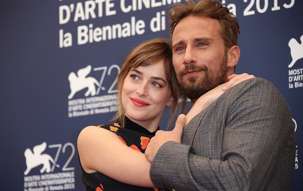 Dakota Johnson and Matthias Schoenaerts pose for photographers at the photo call for the film A Bigger Splash during the 72nd edition of the Venice Film Festival in Venice, Italy.