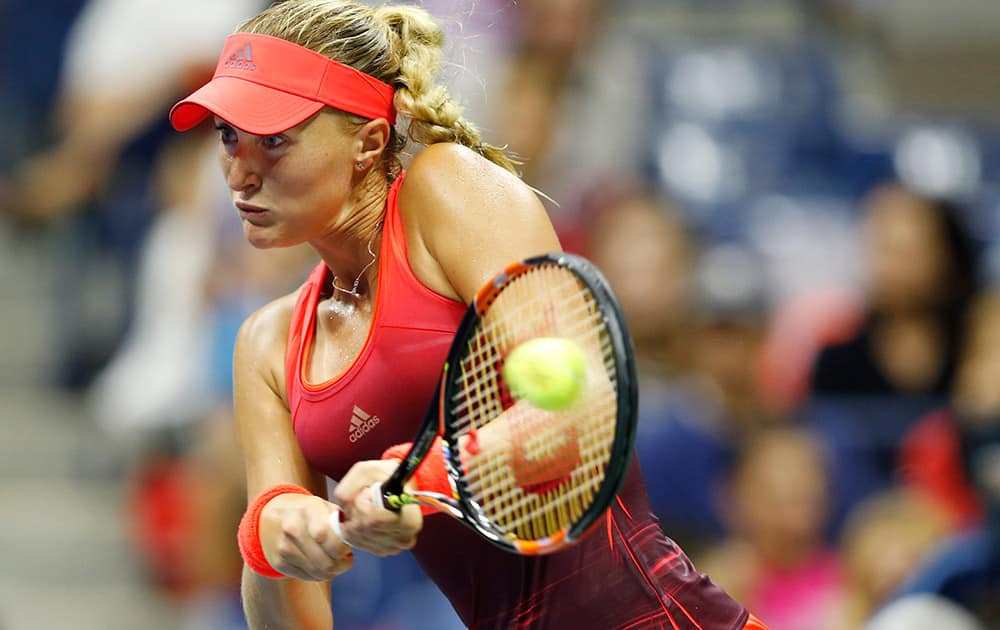 Kristina Mladenovic, of France, returns the ball during her fourth round match against Ekaterina Makarova, of Russia, at the U.S. Open tennis tournament in New York.