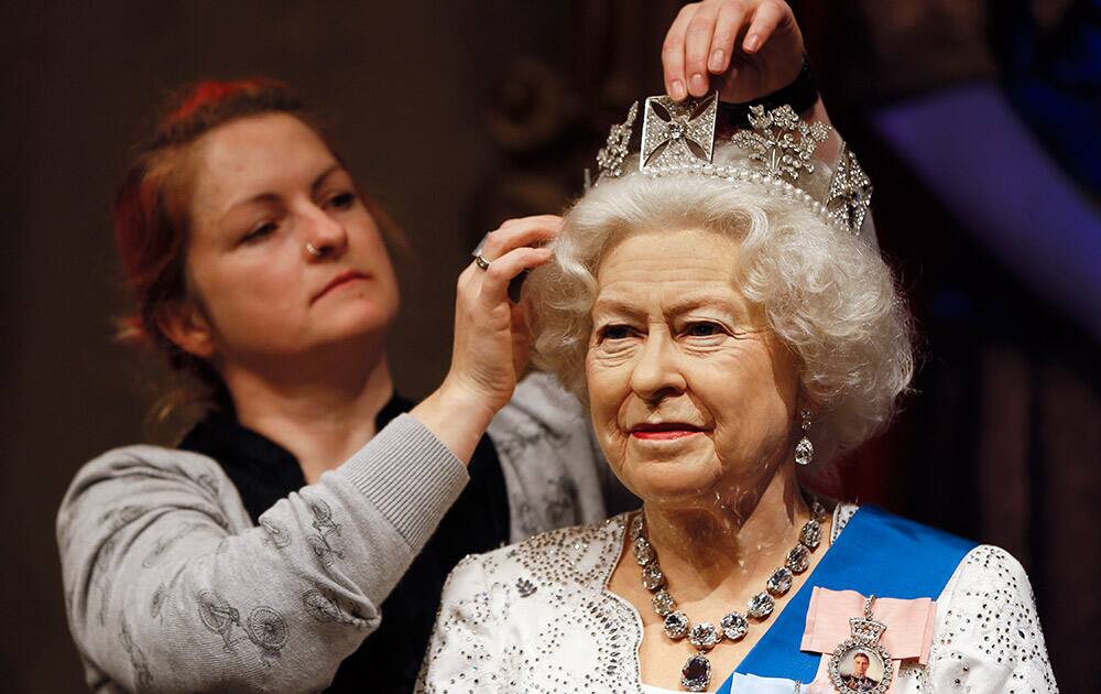 A wax work model of Britain's Queen Elizabeth II is prepared at Madame Tussauds in London.