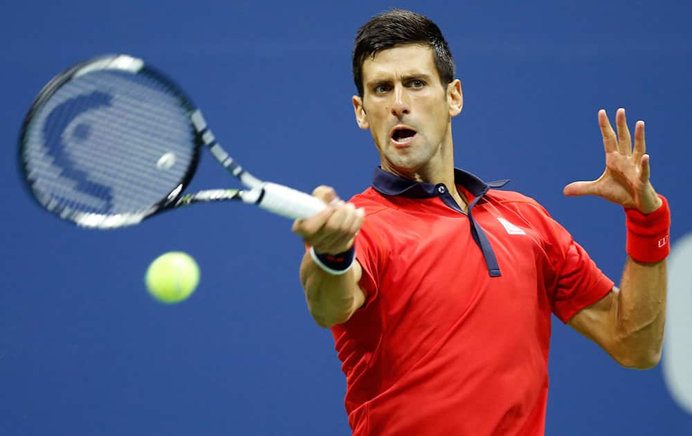 Novak Djokovic, of Serbia, returns the ball during his fourth round match against Roberto Bautista Agut, of Spain, at the U.S. Open tennis tournament in New York.