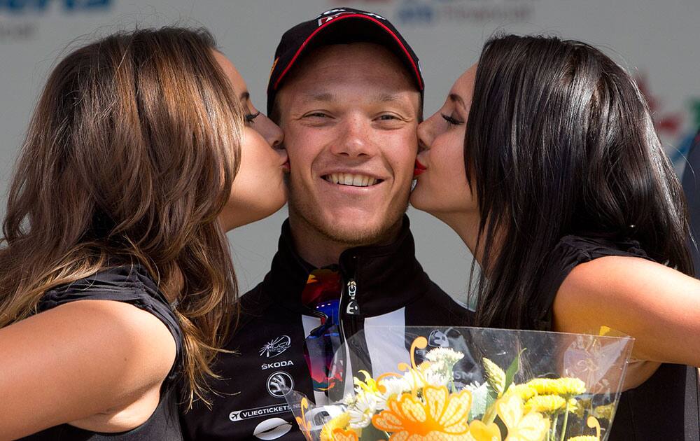 Nikias Arndt, center, of Germany, is kissed following his win of the final stage of the Tour of Alberta cycling race in Edmonton, Alberta.