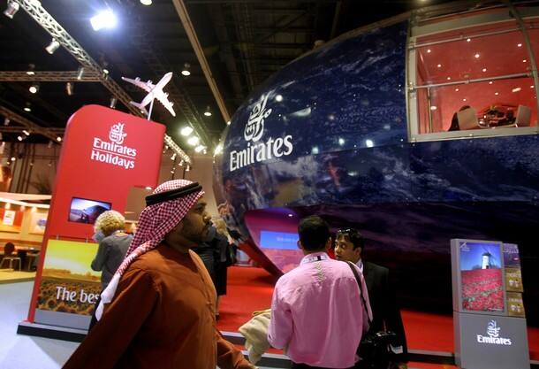 Visitors walk past the Emirates Airlines pavillion