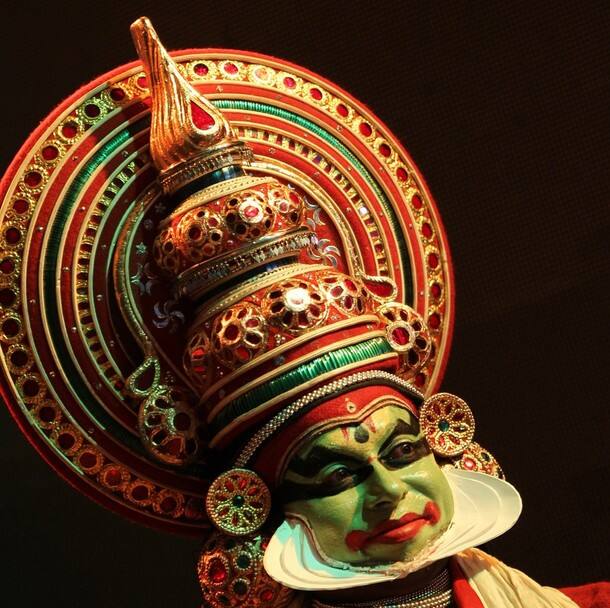 A man in costumes of kathakali, to welcome visitors to the fair.