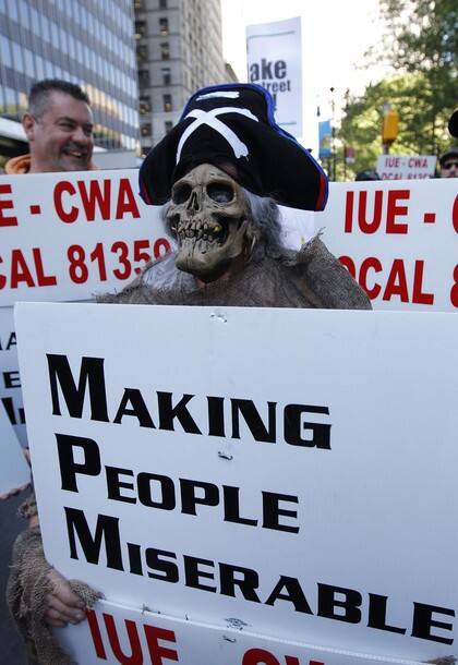 A protester wears a skeleton mask during the 