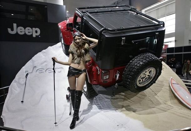 A model poses next to a new Jeep Wrangler made by Chrysler Group 