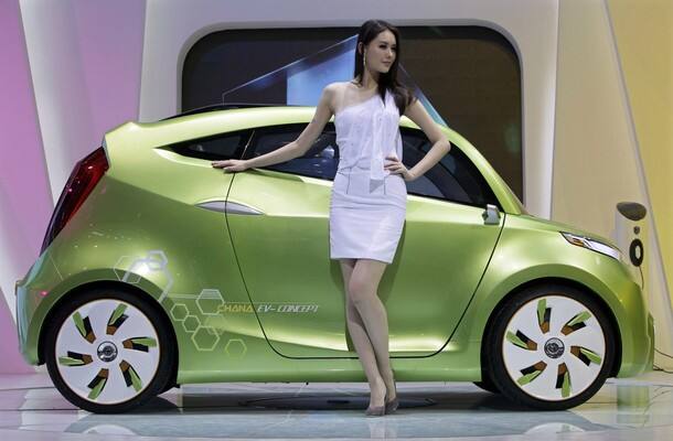 A model poses next to a Chana EV-concept electric car at the Show 