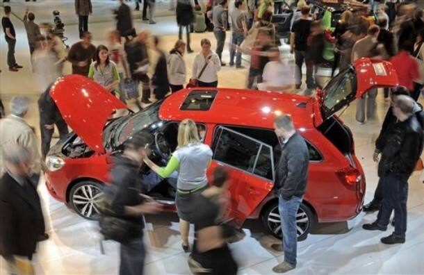 Visitors walk around a Skoda Fabia Combi RS during the fair