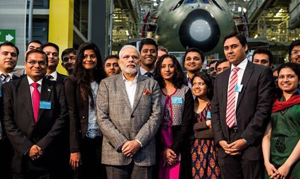 Prime Minister Narenda Modi poses with Indian Airbus workers as they visit the Airbus A380 Final Assembly Lane, in Blagnac Southern France.