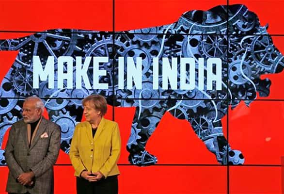German Chancellor Angela Merkel and India's Prime Minister Narendra Modi, left, stand on the podium of the India booth during the opening of the industrial fair in Hanover, Germany, Monday, April 13, 2015.
