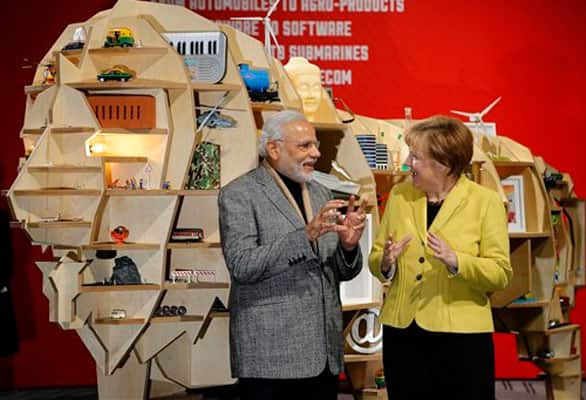 German Chancellor Angela Merkel and India's Prime Minister Narendra Modi chat at the India booth during the opening of the industrial fair in Hanover, Germany, Monday, April 13, 2015.