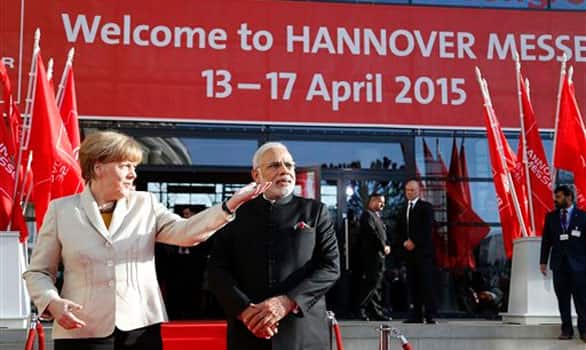 German Chancellor Angela Merkel , left, welcomes India's Prime Minister Narendra Modi at the opening of the industrial fair in Hanover, Germany, Sunday, April 12, 2015.