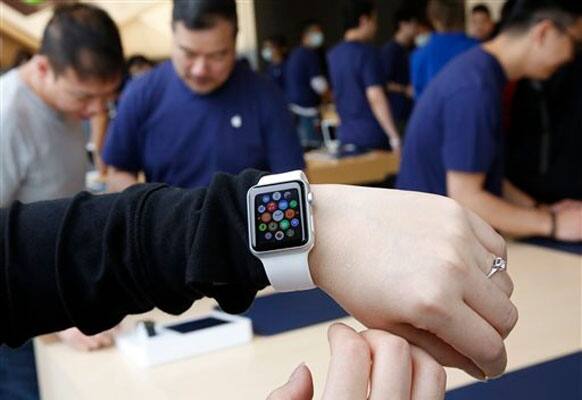 A customer tries on an Apple Watch at an Apple Store in Hong Kong Friday, April 10, 2015. From Beijing to Paris to San Francisco, the Apple Watch made its debut Friday. Customers were invited to try them on in stores and order them online.