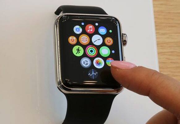 A customer demonstrates Apple Watch at an Apple Store in Tokyo as Apple Watch made its debut Friday, April 10, 2015. Customers were invited to try them on in stores and order them online.