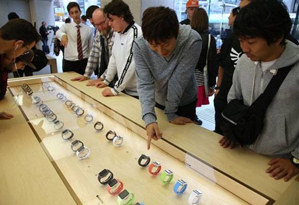 Customers look at a selection of Apple Watches as the public have its first chance to see, touch and pre-order the watch in Sydney, Friday, April 10, 2015.