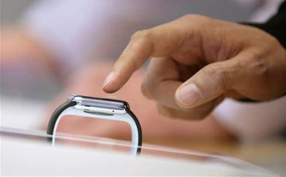 A customer handles an Apple Watch as the public have its first chance to see, touch and pre-order the watch in Sydney, Friday, April 10, 2015. Prices start at $349, but can go as high as $17,000 for a luxury edition in gold.