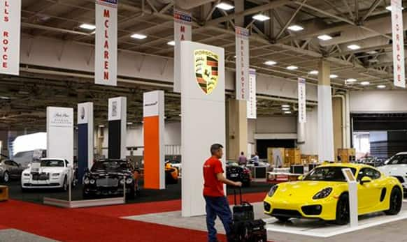 Shawn Burch of Czarnowski Exhibit & Event Marketing looks at a Porsche Cayman displayed in the High End section of the 2015 DFW Auto Show.