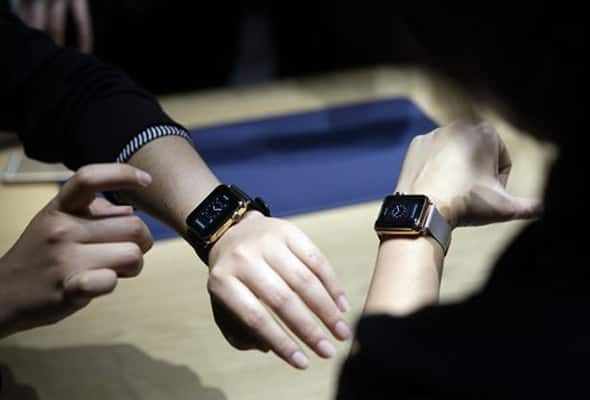 Event attendees get a look at varieties of the new Apple Watch on display in the demo room. 