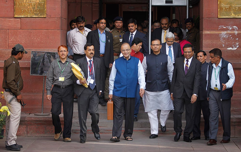 Finance Minister Arun Jaitley, carries a briefcase containing union budget for the year 2015-16 as he leaves his office for Parliament to present the union budget in New Delhi.