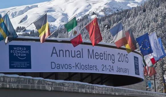 Flags hang on the roof of the Congress Hall were the World Economic Forum will take place in Davos, Switzerland, Monday, Jan. 19, 2015.