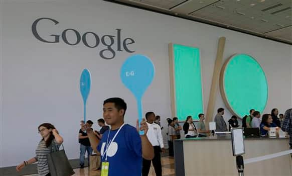 A Google employee helps direct people as they register for Google I/O 2014 in San Francisco, Tuesday, June 24, 2014. 