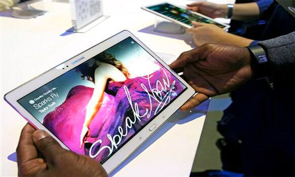 Members of the media try out samples of the Samsung Galaxy Tab S after the tablet was debuted at a press conference in New York, Thursday, June 12, 2014. 