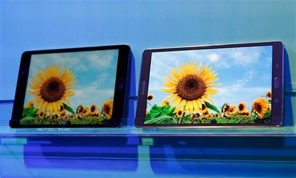 A Samsung Galaxy Tab S, right, is displayed beside it's rival, from Apple, showing a brighter AMOLED screen following a press debut of Samsung's latest tablet in New York, Thursday, June 12, 2014