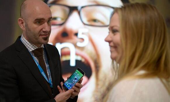 A man holds the new Samsung Galaxy S5 at the Mobile World Congress, the world's largest mobile phone trade show in Barcelona, Spain, Tuesday, Feb. 25, 2014. 