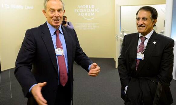 Former British Prime Minister Tony Blair, left, speaks with Sheikh Abdullah Al Thani, right, chairman of Ooredoo of Qatar.