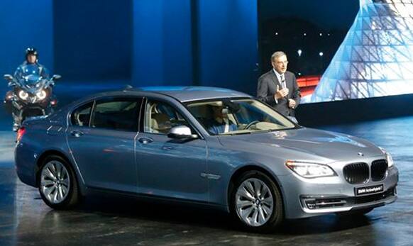 BMW CEO Norbert Reithofer stands beside a BMW 7 Series ActiveHybrid car during the first press day of the 65th Frankfurt Auto Show. 