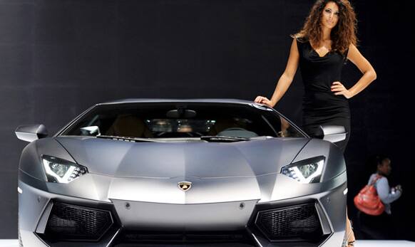 A hostess stands next to Lamborghini Aventator LP 700-4 during the press day of the Frankfurt Auto Show IAA in Frankfurt, Germany. 