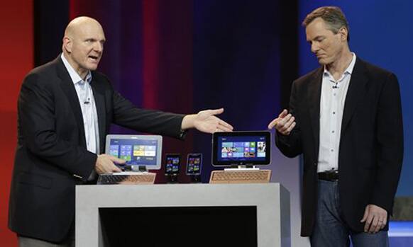 Microsoft CEO Steve Ballmer, left, and Qualcomm CEO Paul Jacobs talk about various Windows based products that utilize Qualcomm technology during Jacobs' keynote address at the Consumer Electronics Show. 