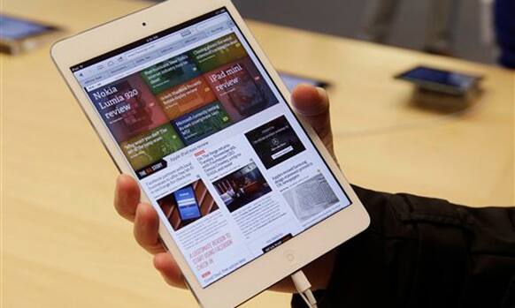 A shopper check out the new Apple iPad mini at the Apple store on Michigan Ave. Friday, Nov. 2, 2012 in Chicago. 