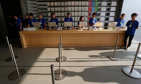 Staff members of Apple Inc. wait for customers as they started selling Apple's iPad Mini at a store in Hong Kong Friday, Nov. 2, 2012. 