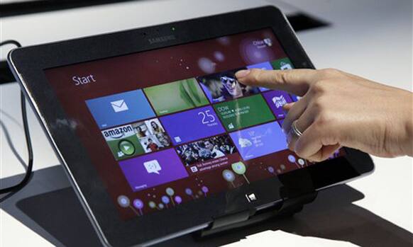 A person tries a Samsung tablet computer running Windows 8 at the launch of Microsoft Windows 8, in New York.