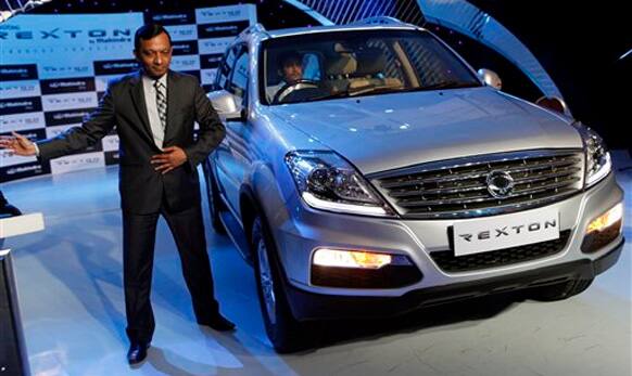 Mahindra and Mahindra Automotive and Farm Equipment Sectors President Pawan Goenka poses with SsangYong Motor Co.'s new car Rexton in Mumbai, India, Wednesday, Oct. 17, 2012.