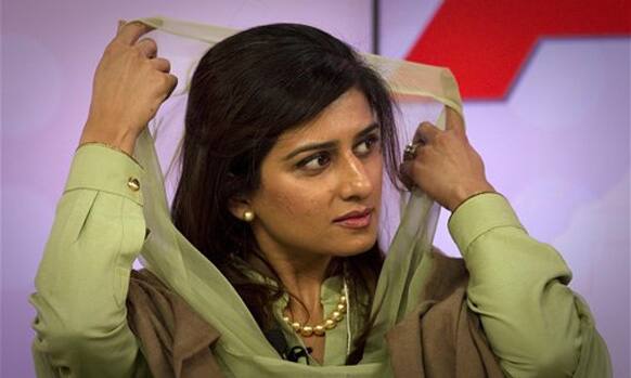 Pakistani Foreign Minister Hina Rabbani Khar adjusts her scarf as she attends the Associated Press debate on 'Democracy' at the World Economic Forum, WEF, in Davos.