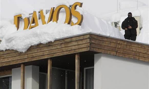 A Swiss police officer stands guard on a roof top of a hotel, the day before the opening of the 42nd Annual Meeting of the World Economic Forum, WEF, in Davos, Switzerland.
