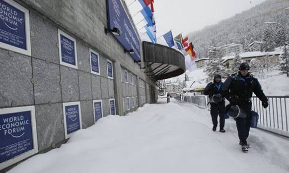 Swiss police officers pass by the Congress Center the day before the opening of the 42nd Annual Meeting of the World Economic Forum, WEF, in Davos, Switzerland.