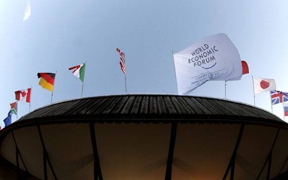 A banner with the logo of the World Economic Forum (WEF) and the national flags of several countries fly on the roof of the congress center in the Swiss mountain resort of Davos.