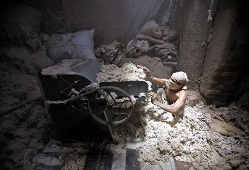 Cotton Spinner: A man works inside a cotton factory in Mumbai. India is the second biggest producer, consumer and exporter of cotton and about sixty percent of the current season shipments went to China, the biggest consumer.