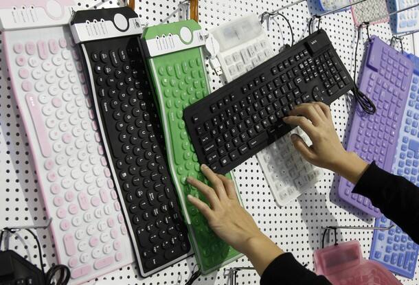 A woman touches a flexible rubber made keyboards by Chinese company China Victory 