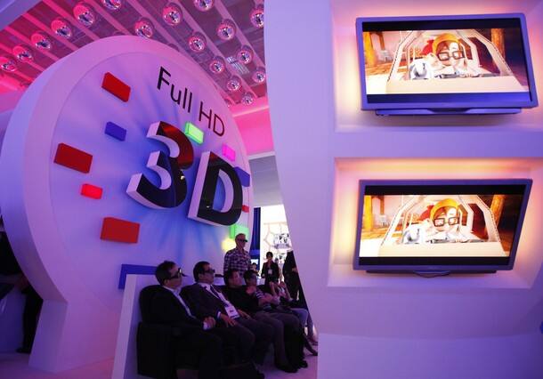 Visitors watch 3D TV at the stand of Philips 