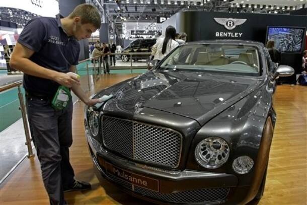 A worker cleans a Bentley Mulsanne