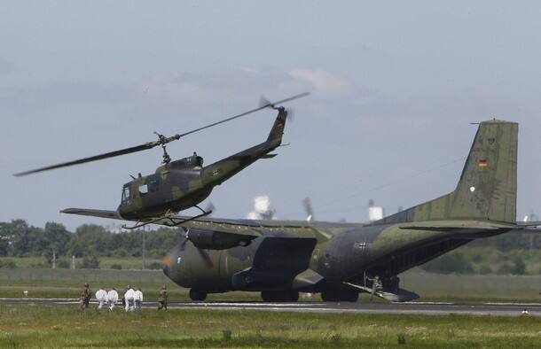 Soldiers of the Bundeswehr enact an evacuation during press day at the ILA International Air Show