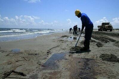 Workers clean up the beach on Elmers Island, Louisiana.