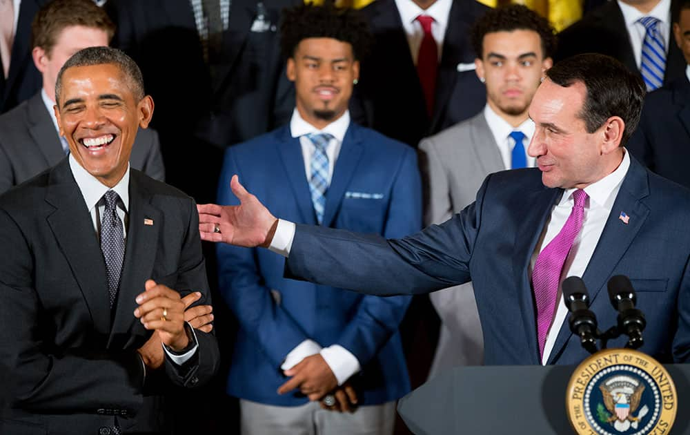 Duke head coach Mike Krzyzewski, right, accompanied by President Barack Obama, left, speaks in the East Room of the White House in Washington.