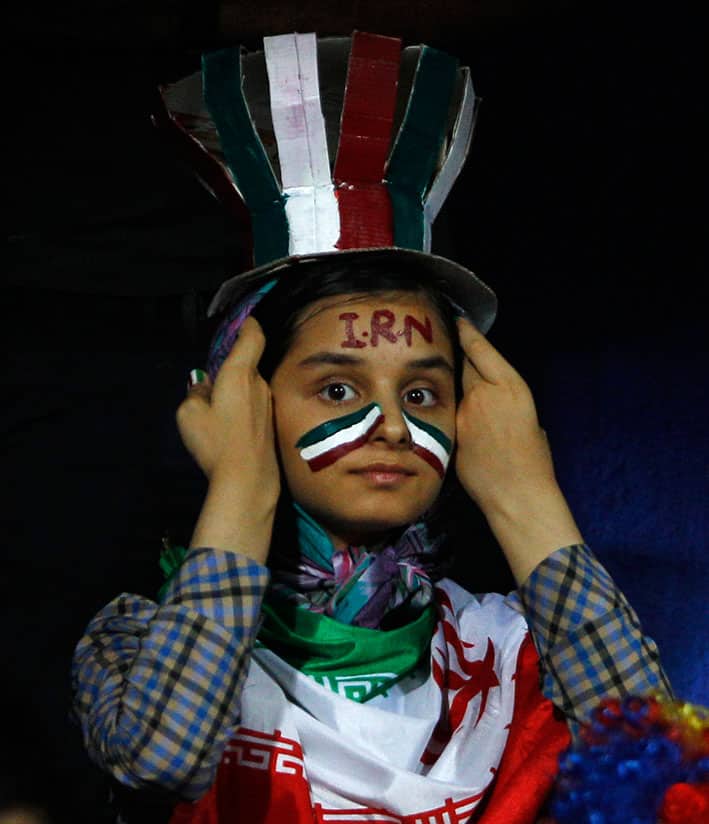 An Iranian girl adjusts her headgear during the 2018 FIFA World Cup qualifying soccer match between Iran and India in Bangalore, India.