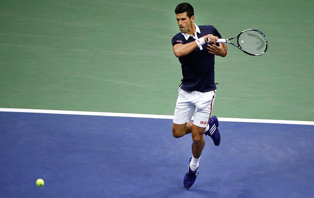 Novak Djokovic, of Serbia, returns a shot to Feliciano Lopez, of Spain, during the quarterfinal round of the US Open tennis tournament.